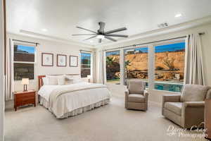 Bedroom featuring ceiling fan, light carpet, and a textured ceiling