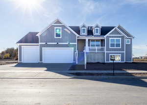 View of front of property featuring a porch and a garage