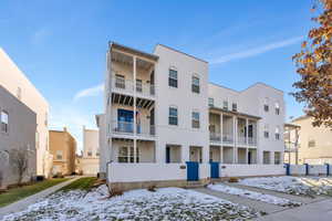 Snow covered building with central AC unit