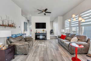 Living room featuring ceiling fan and light hardwood / wood-style flooring