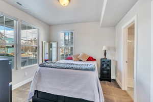 Carpeted bedroom featuring multiple windows