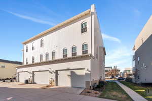 Exterior space featuring cooling unit and a garage