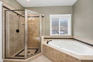 Bathroom featuring tile patterned flooring and plus walk in shower