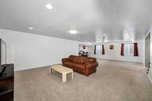 Carpeted living room featuring a textured ceiling