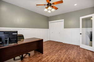 Office area with hardwood / wood-style floors and ceiling fan