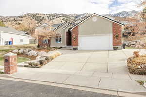 View of property featuring a mountain view and a garage