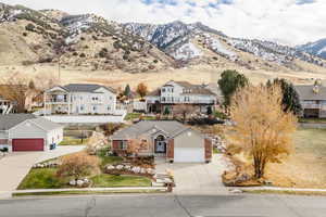 View of front of property featuring a mountain view and a garage