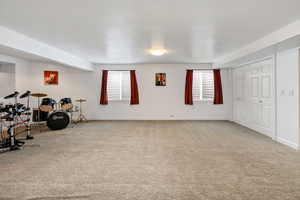 Interior space featuring carpet floors and a textured ceiling