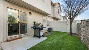 View of yard featuring cooling unit and a patio