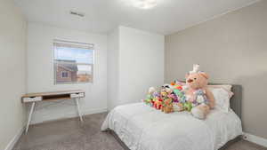 Bedroom featuring carpet flooring and a textured ceiling