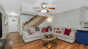 Living room with hardwood / wood-style floors and ceiling fan