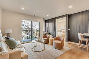 Living area with light hardwood / wood-style flooring