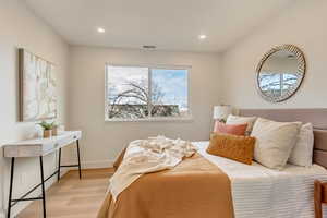 Bedroom with light hardwood / wood-style flooring