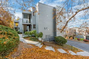 View of side of home featuring a balcony