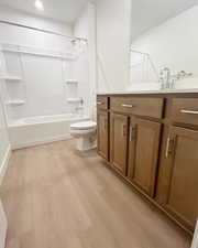 Full bathroom featuring shower / bath combination, vanity, toilet, and wood-type flooring