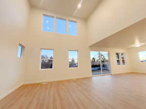 Great Room featuring a high ceiling and light hardwood / wood-style floors