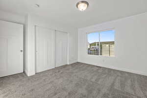 Unfurnished bedroom with carpet floors and a closet