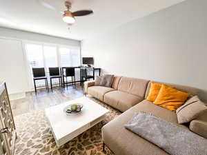 Living room with hardwood / wood-style floors and ceiling fan