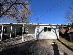 Back of property featuring a carport