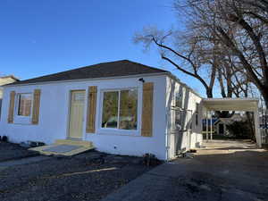 View of front of house with a storage shed