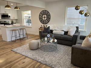 Living room with light hardwood / wood-style flooring