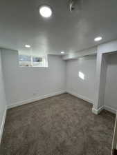 Basement with dark colored carpet