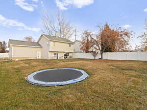 View of yard featuring a trampoline