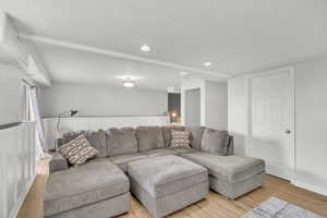 Living room with light hardwood / wood-style floors