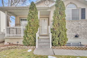 Entrance to property featuring covered porch