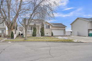 View of front of house featuring covered porch and a garage