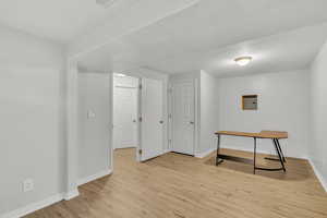 Interior space featuring light wood-type flooring and electric panel