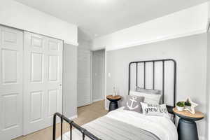 Carpeted bedroom featuring a closet