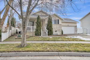 View of front of property featuring a front lawn and a garage