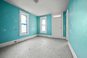 Empty room featuring a textured ceiling