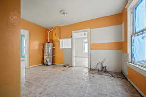 Empty room with secured water heater and ceiling fan