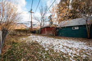 Snowy yard featuring a mountain view