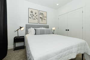 Carpeted bedroom featuring a closet