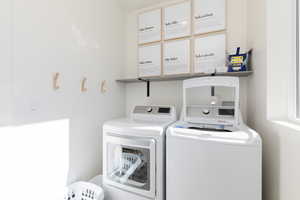 Clothes washing area featuring separate washer and dryer