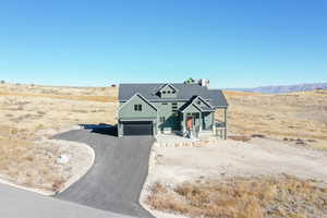 View of front of property featuring a mountain view and a garage