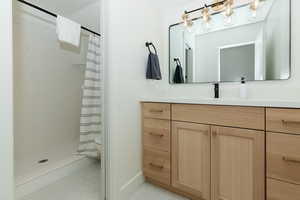 Bathroom featuring vanity and walk in shower