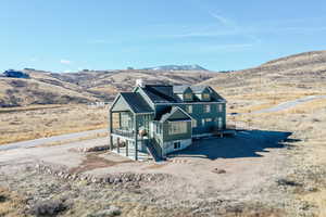 Back of house with a deck with mountain view