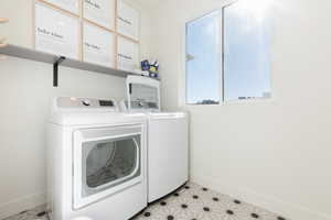 Clothes washing area featuring washing machine and dryer