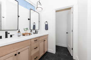 Bathroom with tile patterned floors and vanity