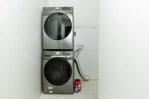 Washroom with stacked washer and clothes dryer