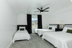 Bedroom with carpet, ceiling fan, and lofted ceiling