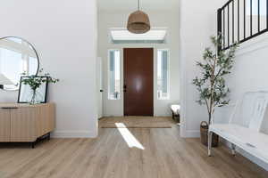 Foyer entrance featuring a wealth of natural light and light hardwood / wood-style flooring