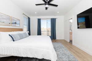 Bedroom with ceiling fan, ensuite bath, access to outside, and light hardwood / wood-style flooring