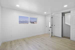 Unfurnished bedroom featuring light hardwood / wood-style floors and a closet