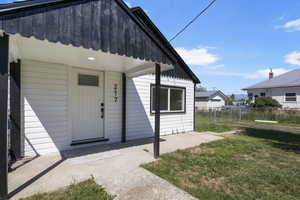 Doorway to property with a yard