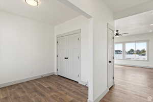 Unfurnished bedroom with a textured ceiling, hardwood / wood-style flooring, and ceiling fan